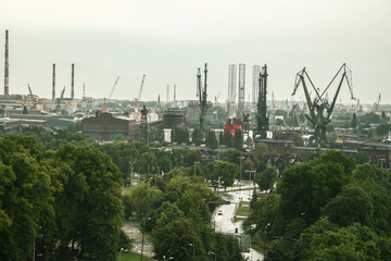 Panorama of the Gdansk shipyard with its distinctive cranes and ships being built and repaired. Also called stocznia gdanska, the shipyards are an industrial and historical landmark of Poland - obrazy, fototapety, plakaty