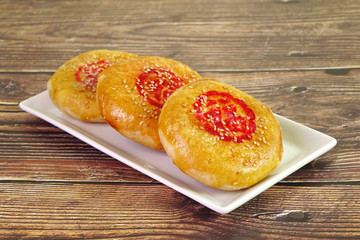 A sweetheart cake (Lao Po Bing) or wife cake or marriage pie is a traditional Cantonese pastry with a thin crust of flaky pastry. (Red Chinese word “Fu” on cake mean “Happiness”) Selective focus