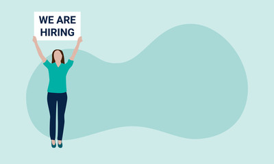 Vector illustration of a white woman in green shirt and blue pants standing on the left, holding a white sign that reads we are hiring. Sign can be changed. Isolated against a green background.