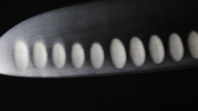 Chef's knife close-up. Reflection on the steel blade of knife. Dark background