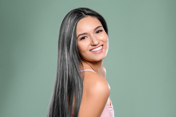 Portrait of beautiful model with grey hair on green background