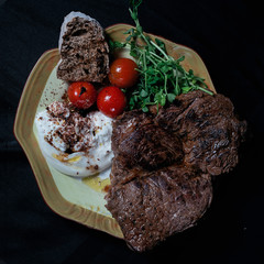 Beef medium rare steak cherry tomatoes and burrata