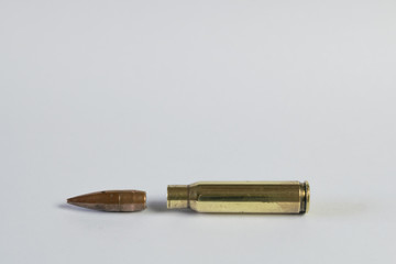 Metal rifle bullet with bronze and gold colors