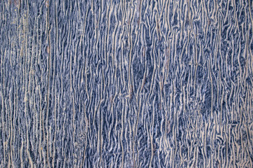 Crumpled wall for backdrop. Paint color is blue with white. Chaotic vertical folds.