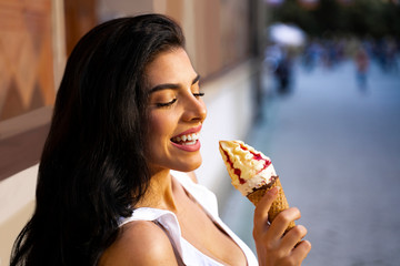 Closeup happy woman eating ice cream cone