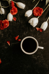 cup of coffee red and white flowers black background
