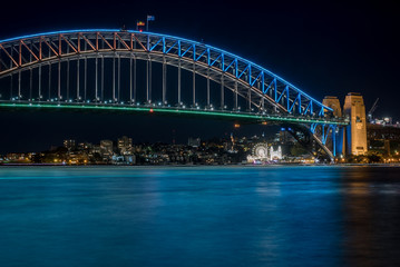 Sydney Harbour Bridge illuminated in blue light at night time