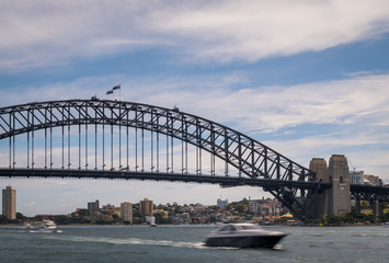 Fototapeta na wymiar Boats at Sydney Harbor Bridge on a sunny day at Circular Quay, Australia