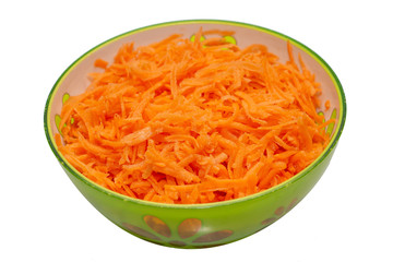 Shredded  carrots in a bowl on a white background. Vegetable carrot salad in a green plate.