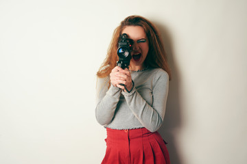  model of the 80s. 90's, with bright blue make-up, dereit the old video camera and smiles,...
