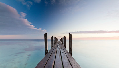 Wooden jetty at sunrise in Quindalup, Western Australia © Milbsie