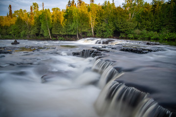 Running rocky, levelled river in Ontario, Canada. Taken in the summer with forest, woods background...