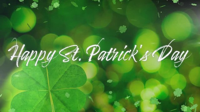 Word Happy St. Patricks day with animation of clovers falling on green background