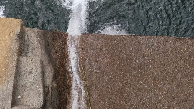 Water is coming out with heavy force from a dam.