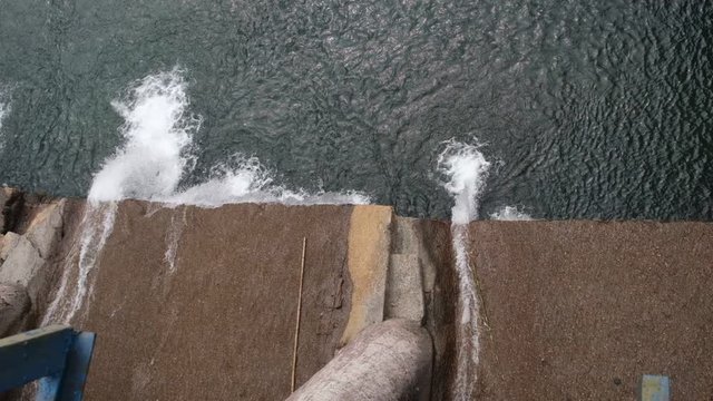 Water is coming out with heavy force from a dam.