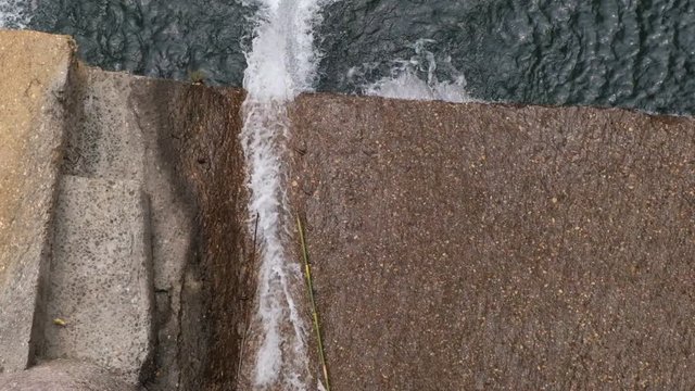 Water is coming out with heavy force from a dam.