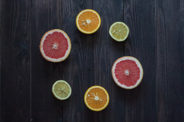 Fototapeta na wymiar lemon, orange and grapefruit on a wooden background