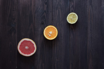 lemon, orange and grapefruit on a wooden background