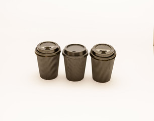 Recyclable take out coffee or teacups with lids isolated against a white background.