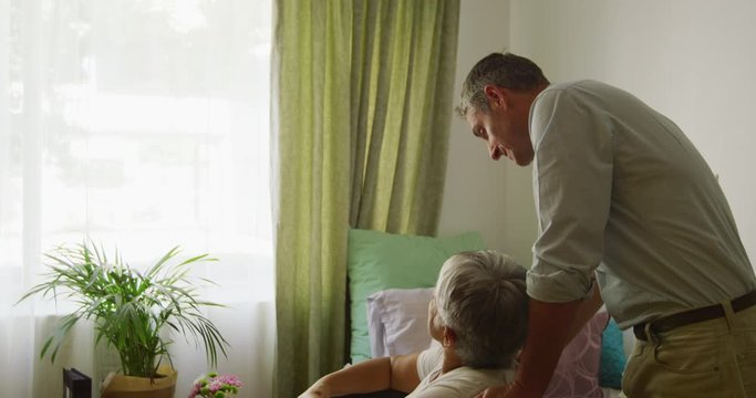 Doctor helping senior woman in her room of retirement house