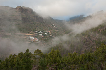 Village of El Juncal in the fog. El Juncal ravine. The Nublo Rural Park. Tejeda. Gran Canaria. Canary Islands. Spain.