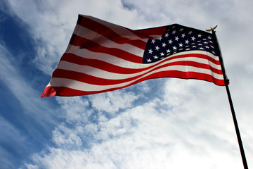 USA flag on a background of bare sky. Independence Day and USA.