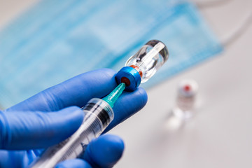 close up on vaccine and medical syringe