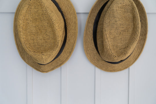 Two hats on wall background, vintage hat style.