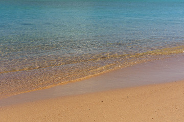 Fototapeta na wymiar Closeup of the sand on beach and Red sea water