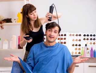 Young attracrive man visiting female barber