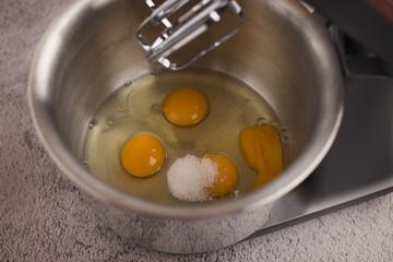 Eggs are beaten with a mixer and sprinkled with salt.