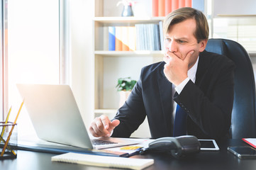 Young business man are busy working in the office. He using laptop on desk in office room