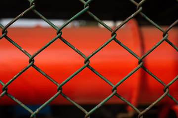 Fototapeta premium old and rusty green chain fence puts up on factory for security reason