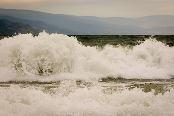 Waves crashing into shore during a windy storm