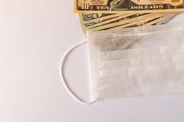 CORONAVIRUS. Protective medical mask with American dollars. Close up. Selective focus.