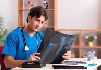 Young handsome doctor radiologyst working in clinic