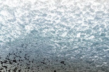 Abstract blurred pattern of rain and snow on glass as background.