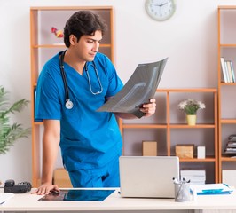 Young handsome doctor radiologyst working in clinic