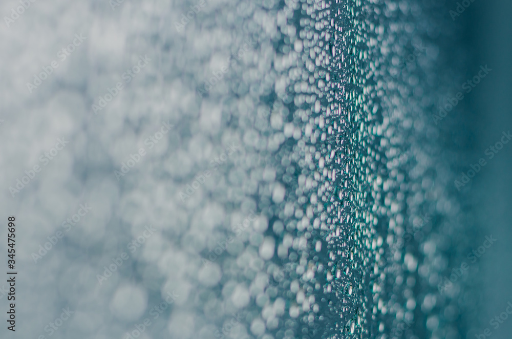 Wall mural blurred and focus of rain drop on glass window in monsoon season for abstract and background concept