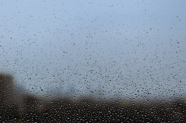 Rain drop on glass window in monsoon season for abstract and background concept.