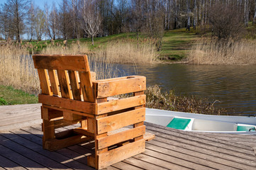Rustic chair from old used pallets on wooden deck