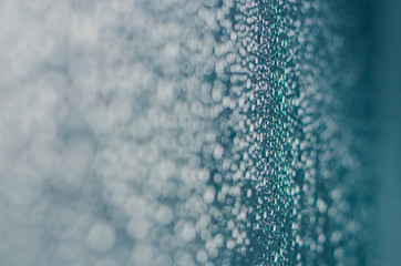 Blurred and focus of rain drop on glass window in monsoon season for abstract and background concept.
