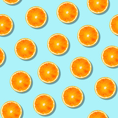 Seamless orange fruit pattern on blue background.