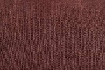 Dark cherry Denim Texture. Denim background of jeans of unusual color