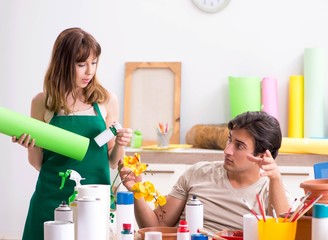 Couple decorating pots in workshop during class