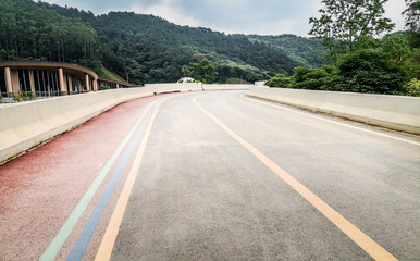 Background material of asphalt road in natural forest, road of automobile advertisement.