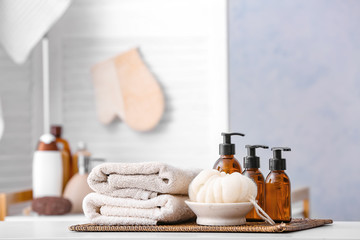 Shower gels, towels and loofah in bathroom