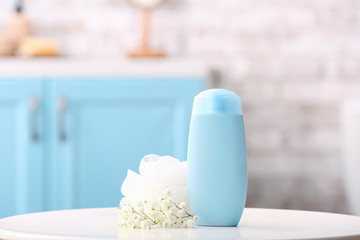 Shower gel and loofah in bathroom