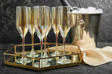 Bucket with ice and champagne on dark background
