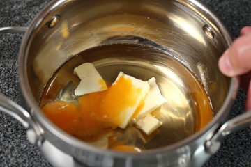Adding egg yolks in pan with reduced cider and butter. Making Cider Pie Series.